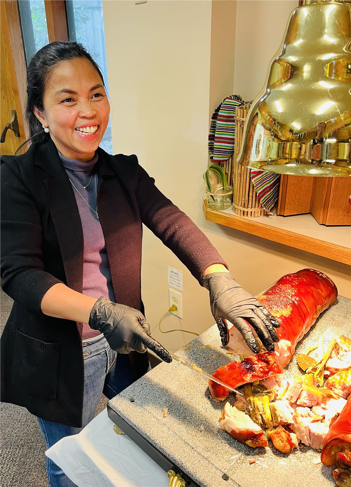 Chef Marie carving lechon at a catered event