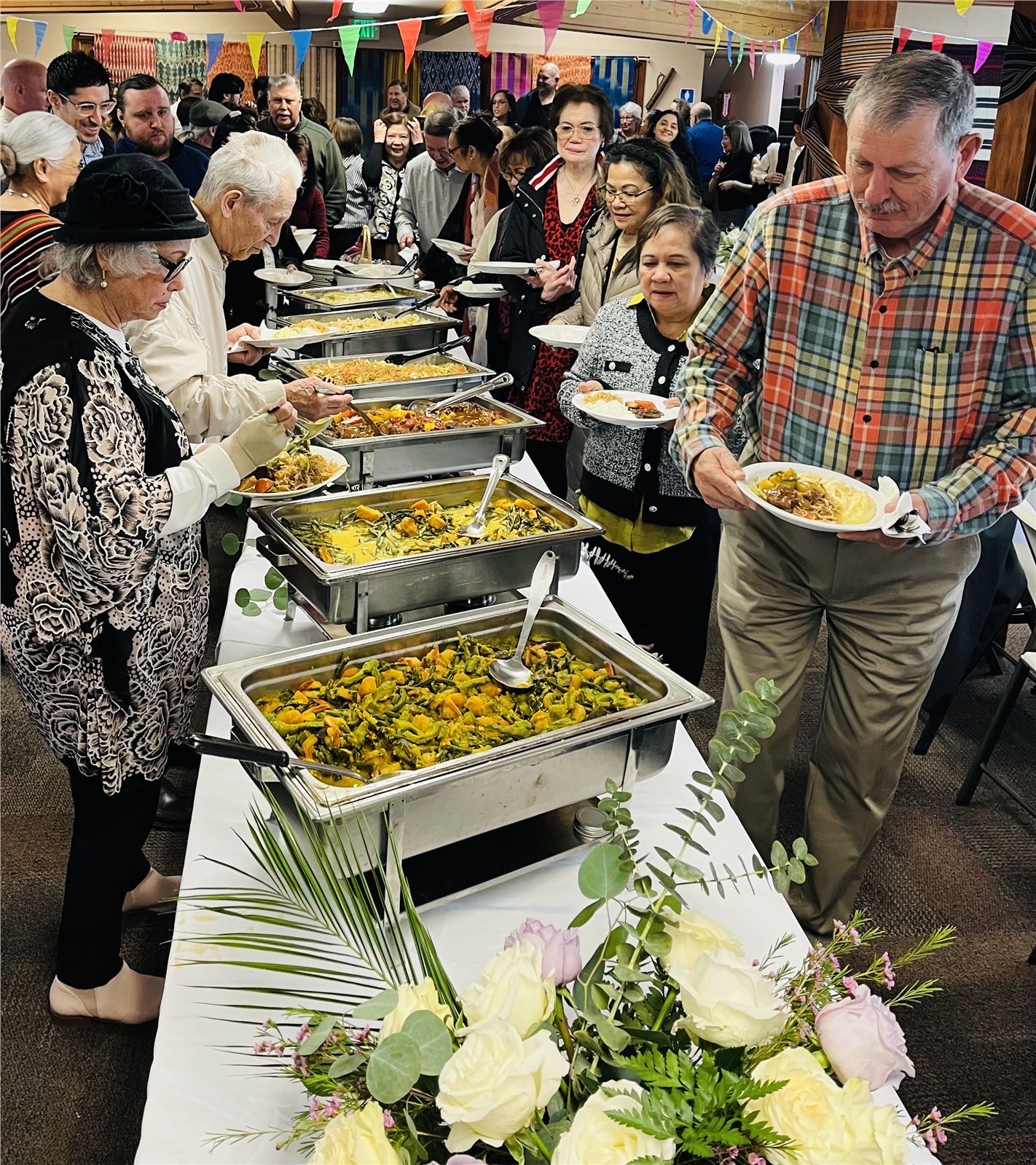 Guests serving themselves from a generous Filipino buffet